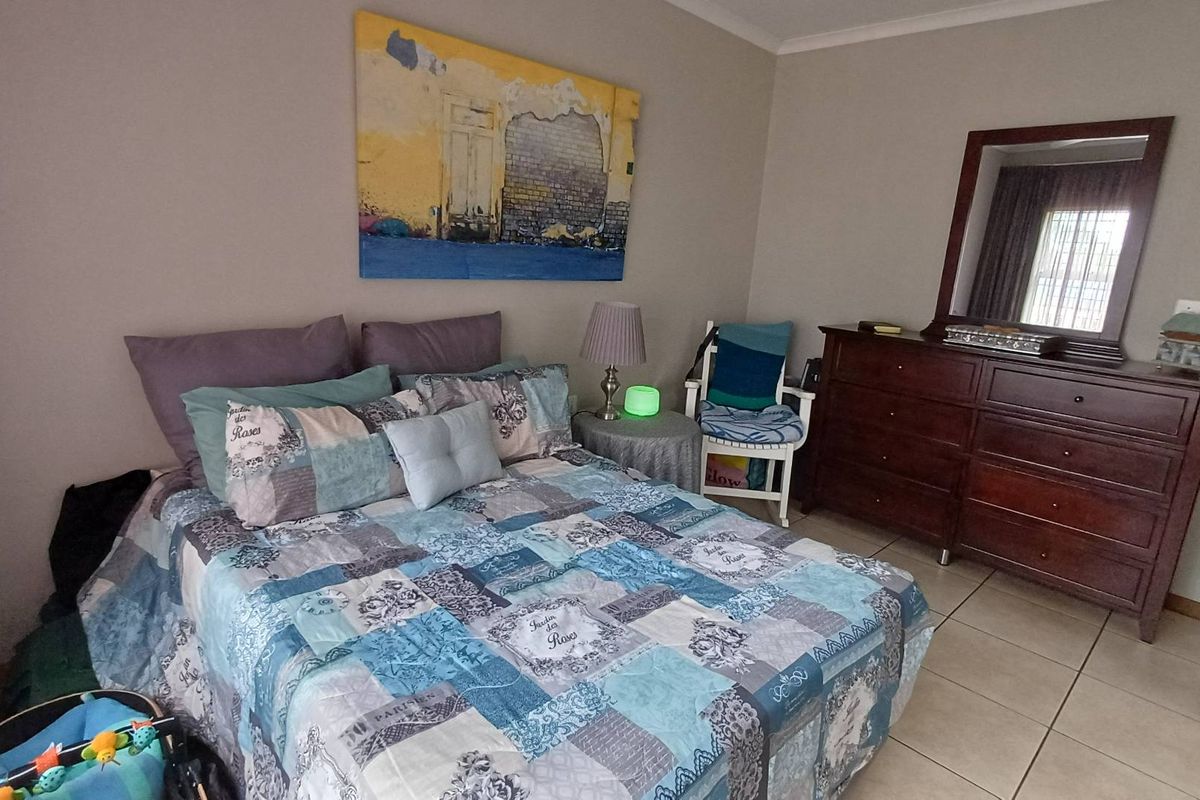 A well-maintained bedroom featuring neutral wall tones and tiled flooring, providing a comfortable and functional living space.