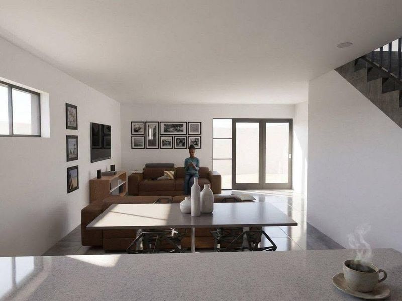 Open plan living area featuring a modern staircase, tiled flooring, and sliding glass doors leading to the exterior.