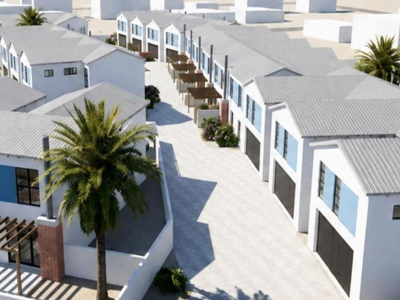 An aerial view of a modern townhouse development featuring uniform pitched roofs, paved driveways, and integrated garage access.