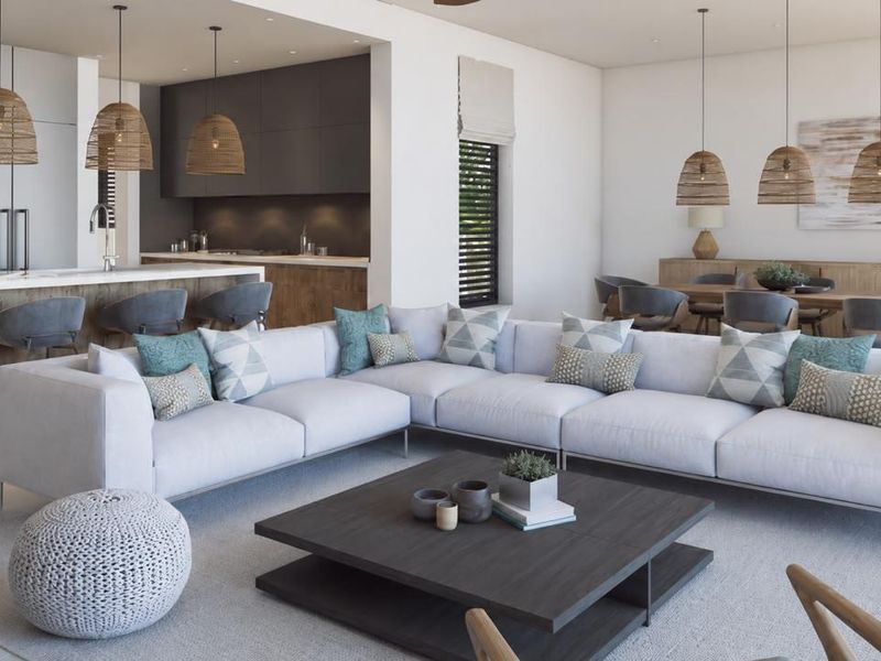 Spacious open-plan living area featuring a modern kitchen with island, integrated appliances, and seamless flow into the dining and lounge spaces.