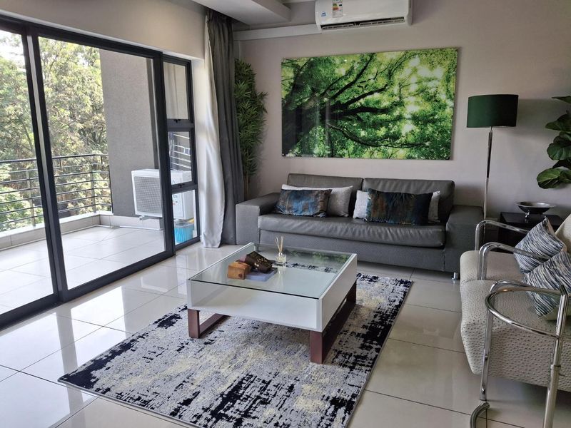 Modern living room featuring large format floor tiles, a split-system air conditioner, and seamless access to an outdoor balcony through sliding glass doors.