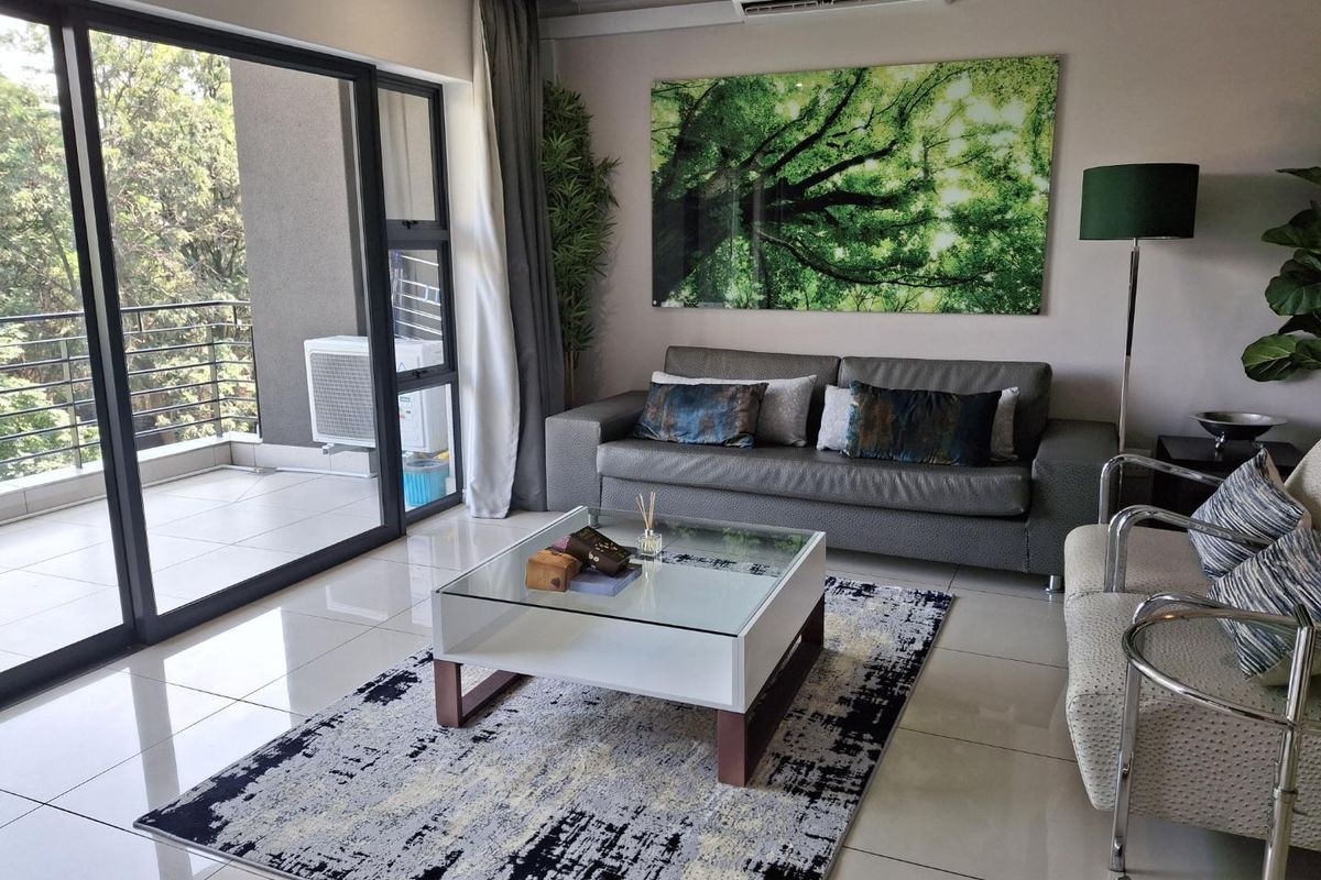 Modern living room featuring large format floor tiles, a split-system air conditioner, and seamless access to an outdoor balcony through sliding glass doors.
