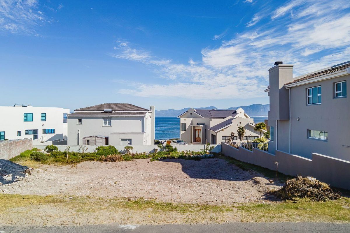 A vacant residential plot situated in a coastal neighborhood, offering potential for development with surrounding established homes and ocean views.