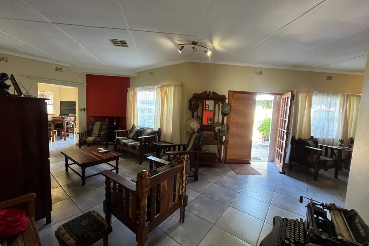 Spacious living room featuring tiled flooring, a fireplace, and direct access to the outdoor patio area.