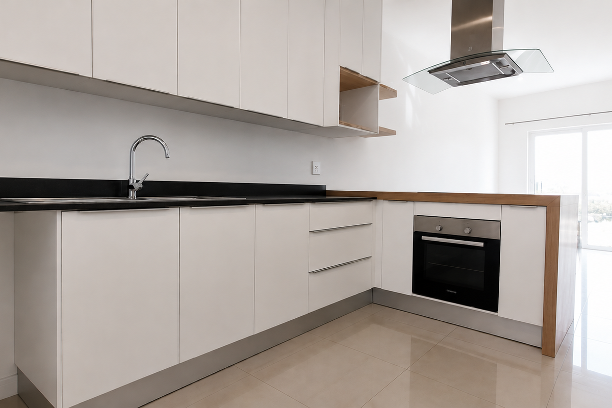 Modern kitchen featuring sleek white cabinetry, stainless steel appliances, and tiled flooring, offering a clean and functional space.