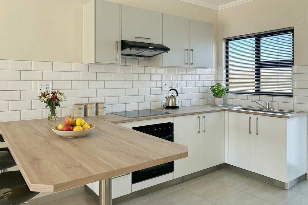 Kitchen with built-in cupboards & oven.