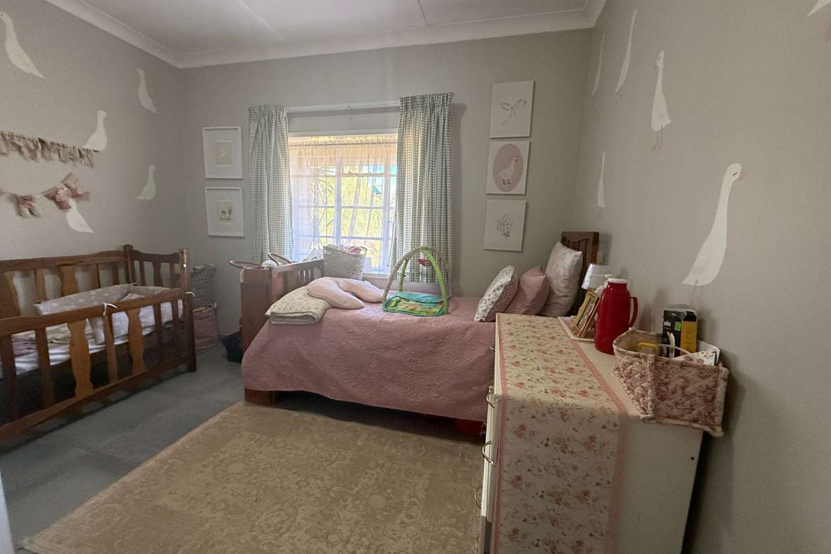 A bedroom featuring neutral wall paint, coving, and a window with natural light.