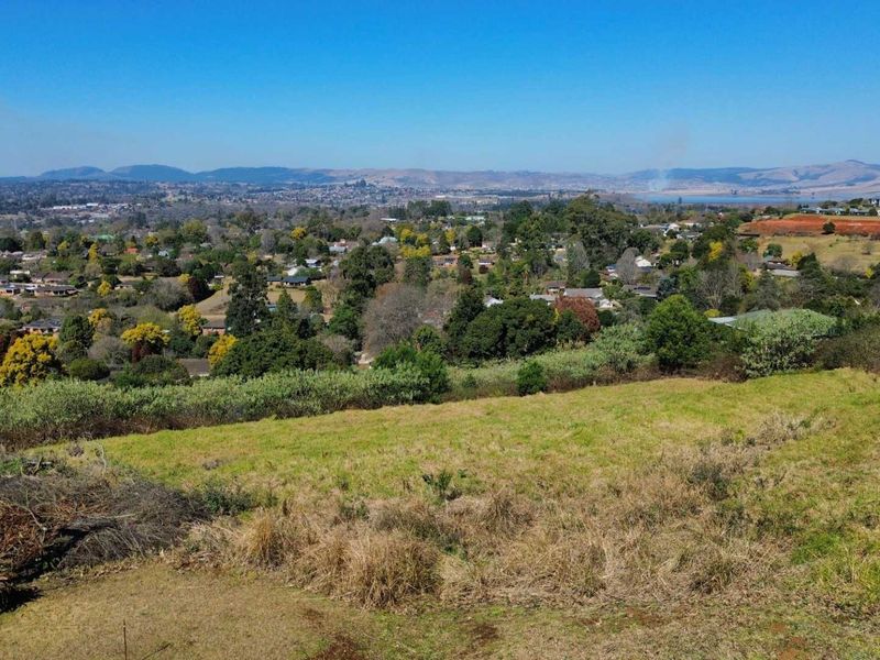 Elevated view overlooking the surrounding residential neighborhood and distant landscape from the vacant land plot.
