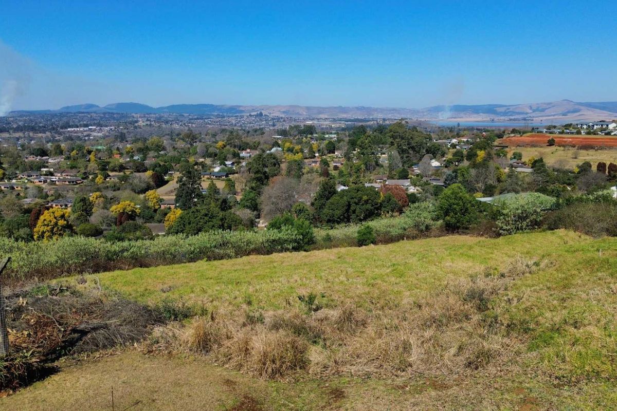Elevated view overlooking the surrounding residential neighborhood and distant landscape from the vacant land plot.