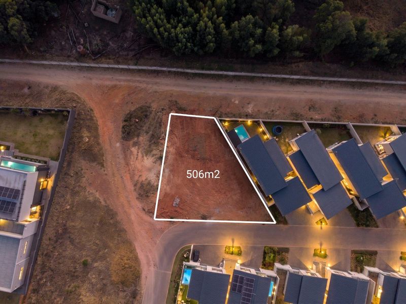 Aerial view of a 506m2 vacant residential plot situated within a developed estate, ready for new construction.