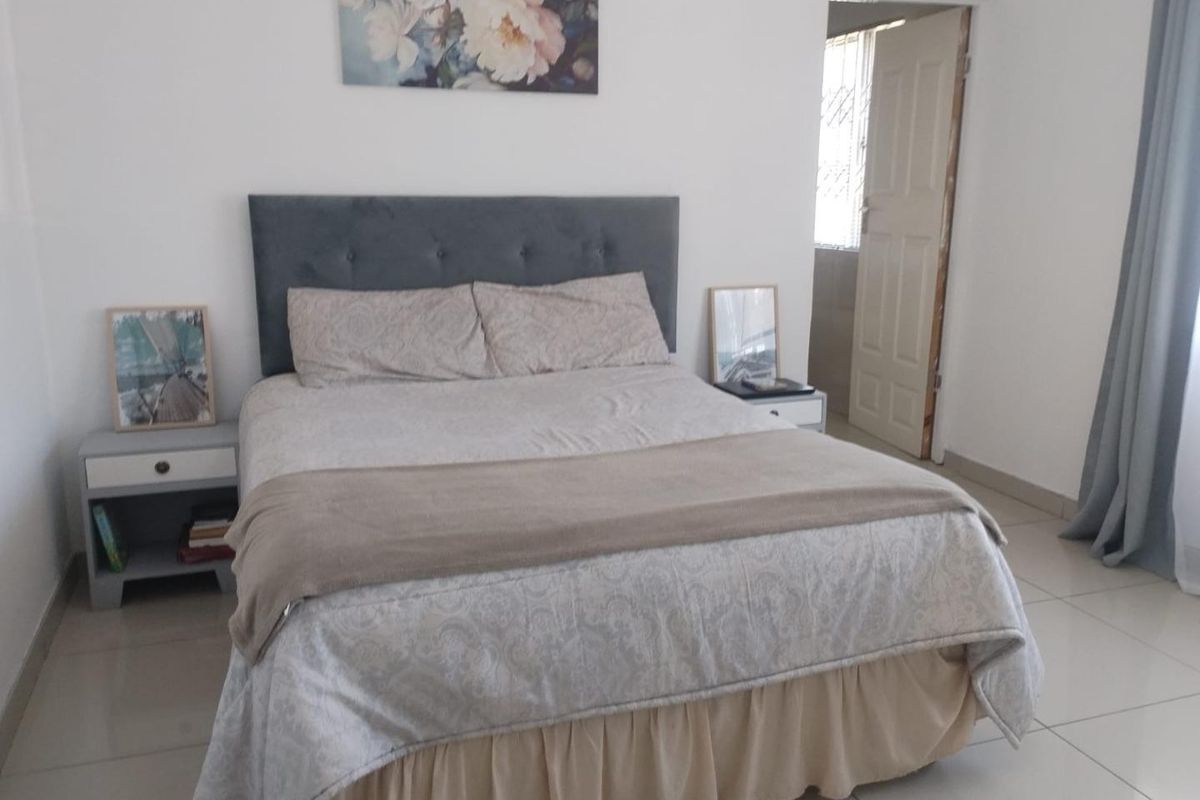 A bedroom featuring neutral tiled flooring and white walls, providing a clean and simple foundation for personal styling.