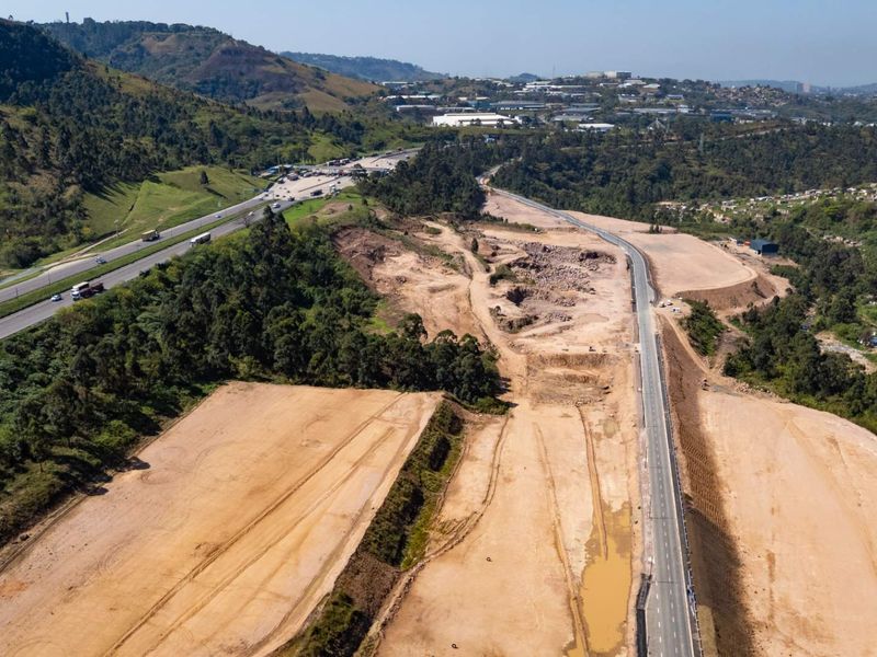Aerial view of a large industrial development site featuring extensive earthworks, graded land, and direct access to major highway infrastructure.