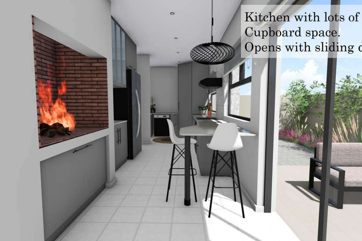 Modern kitchen featuring built-in cabinetry, a brick-lined indoor braai, and seamless access to the outdoor patio through large sliding doors.