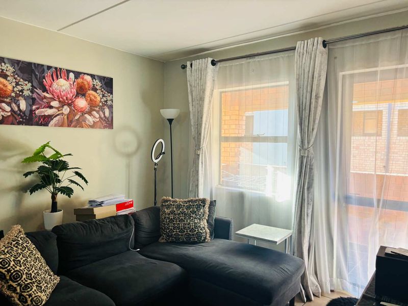 A comfortable living room featuring a large sliding glass door that provides natural light and access to the exterior.