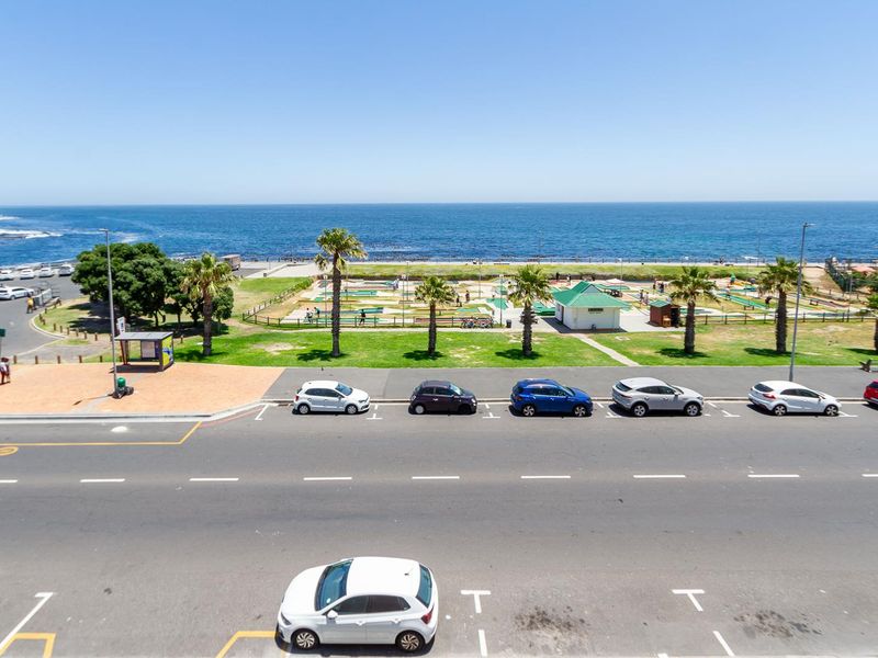 Elevated view overlooking the coastal road, public park, and ocean horizon.
