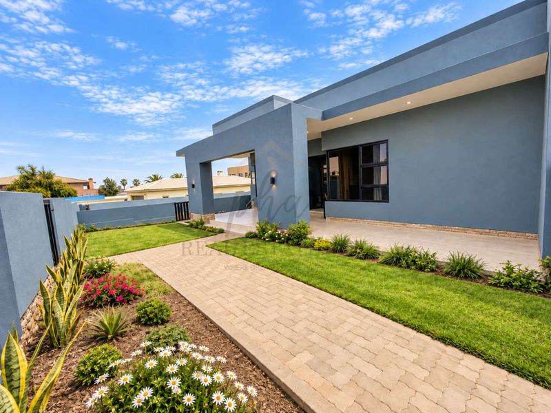 A well-maintained rear exterior featuring a paved walkway, landscaped garden, and a covered patio area with modern finishes.
