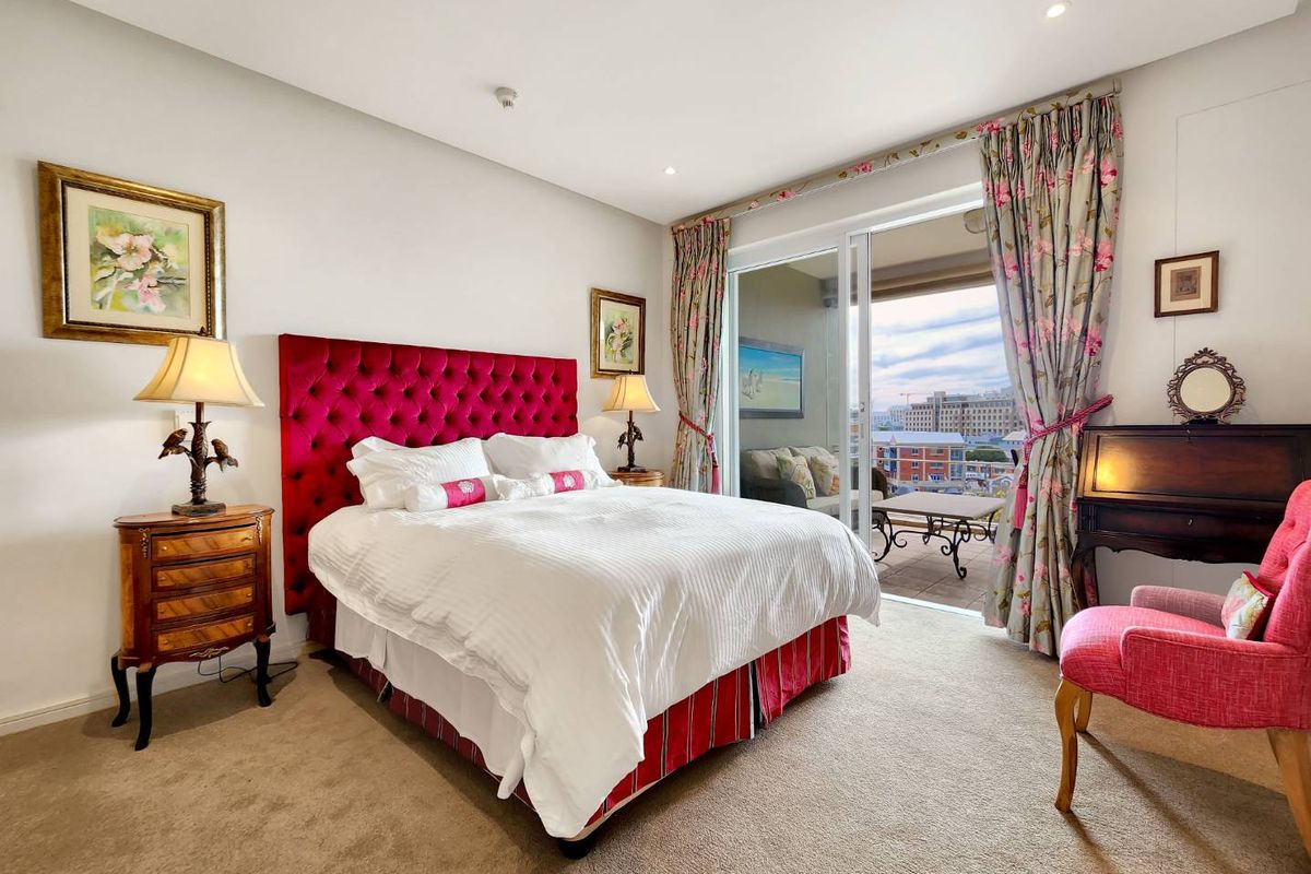 A well-maintained bedroom featuring recessed lighting, carpeted floors, and direct access to a private balcony through sliding glass doors.