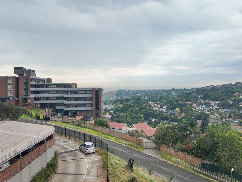 Elevated view overlooking the surrounding residential neighbourhood, local apartment complex, and access driveway.
