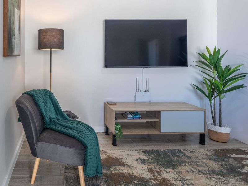 A well-maintained living area featuring neutral wall finishes and durable tiled flooring, providing a clean and functional space.