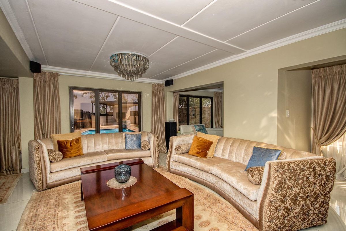 Spacious living room featuring large sliding glass doors with direct views and access to the outdoor pool area.