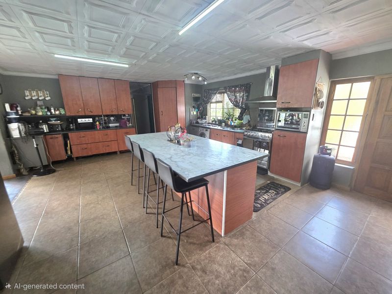 Spacious kitchen featuring a central island, built-in cabinetry, gas stove with extractor, and tiled flooring under a coffered ceiling.