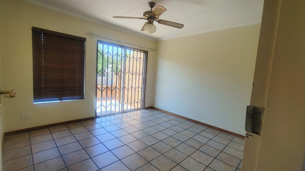 Main bedroom upstairs with opening onto balcony