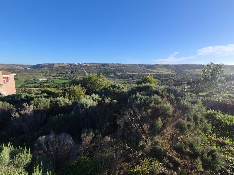 A scenic elevated view overlooking the surrounding natural landscape and rolling hills, showcasing the property's expansive outlook.