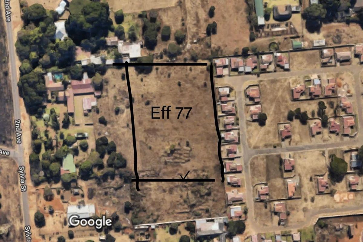 Aerial view of the vacant agricultural land plot identified as Eff 77, showing surrounding residential development and access roads.