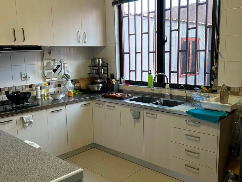 Functional kitchen featuring white built-in cabinetry, stainless steel countertops, double sink, and tiled finishes, offering a practical layout for daily meal preparation.