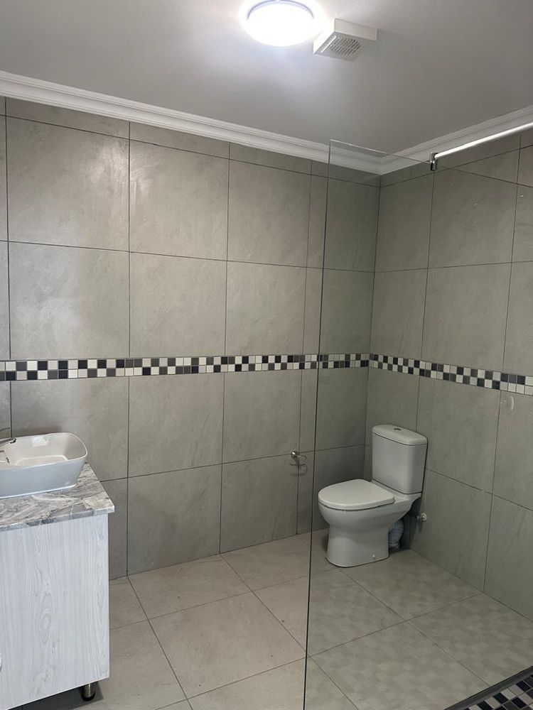 First bathroom with shower and toilet