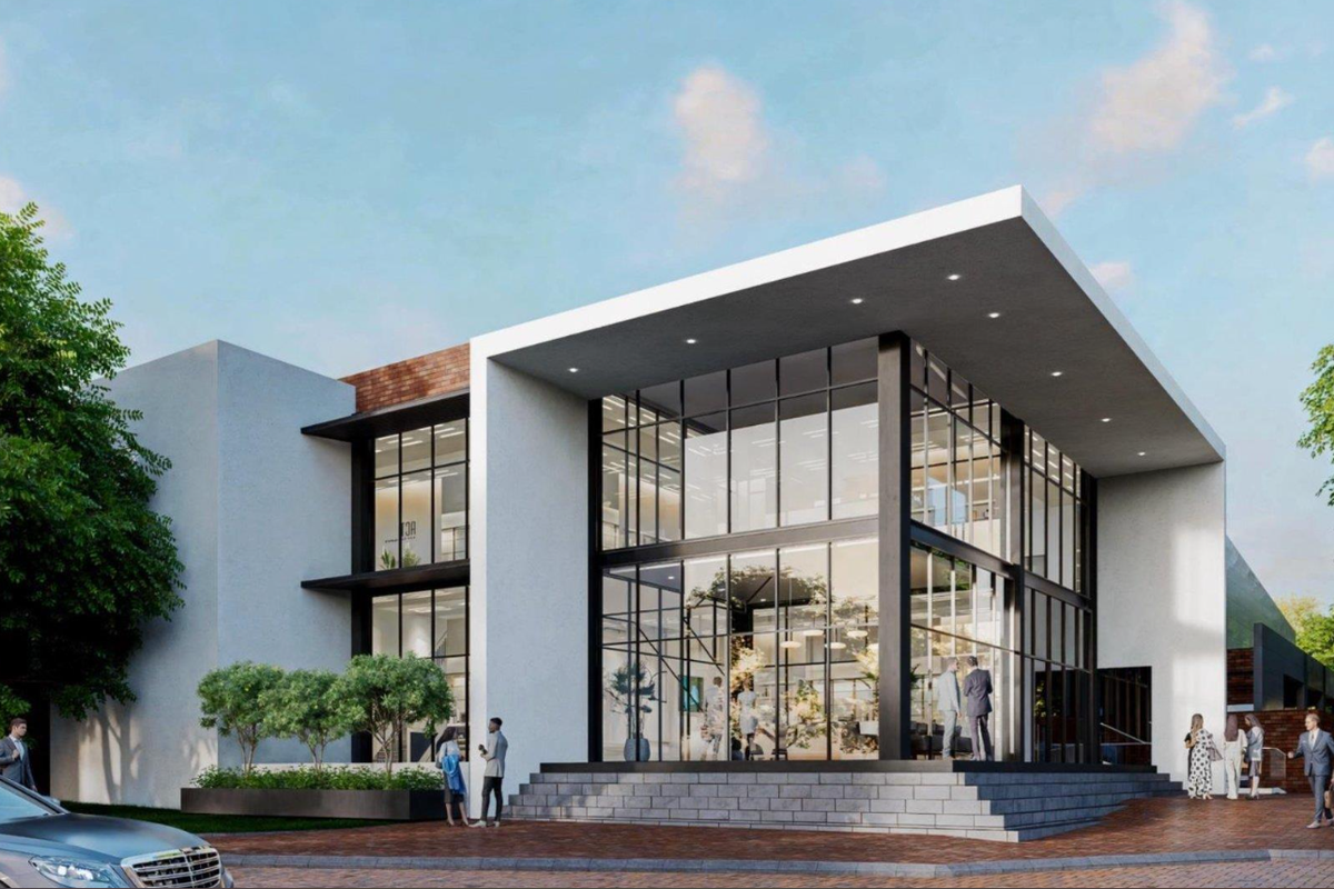 Modern office building facade featuring a striking glass curtain wall, steel structural elements, and a prominent cantilevered roof design.