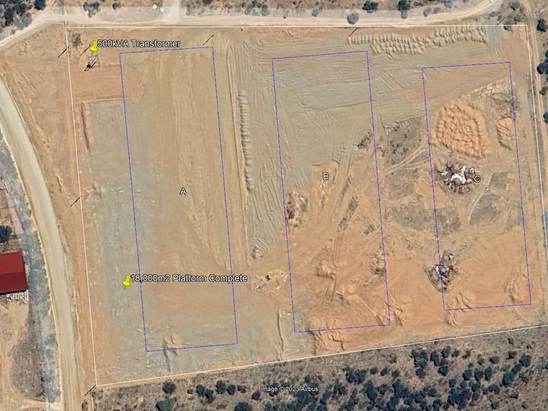 Aerial view of an industrial site featuring prepared building platforms and an on-site 500kVA transformer.
