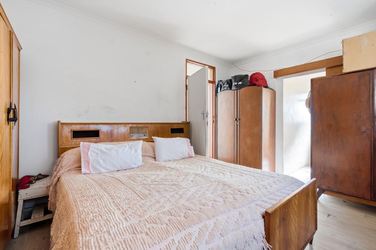 A bedroom featuring neutral walls and standard finishes, requiring cosmetic updates to improve the overall aesthetic and condition of the space.
