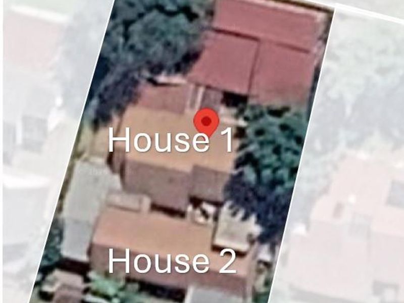 An aerial satellite view showing the roof layout and footprint of two residential houses on the property.
