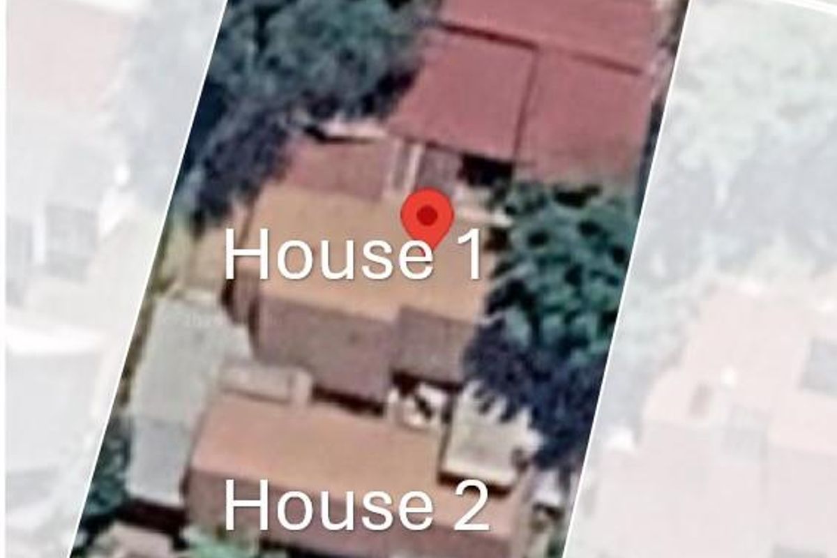 An aerial satellite view showing the roof layout and footprint of two residential houses on the property.