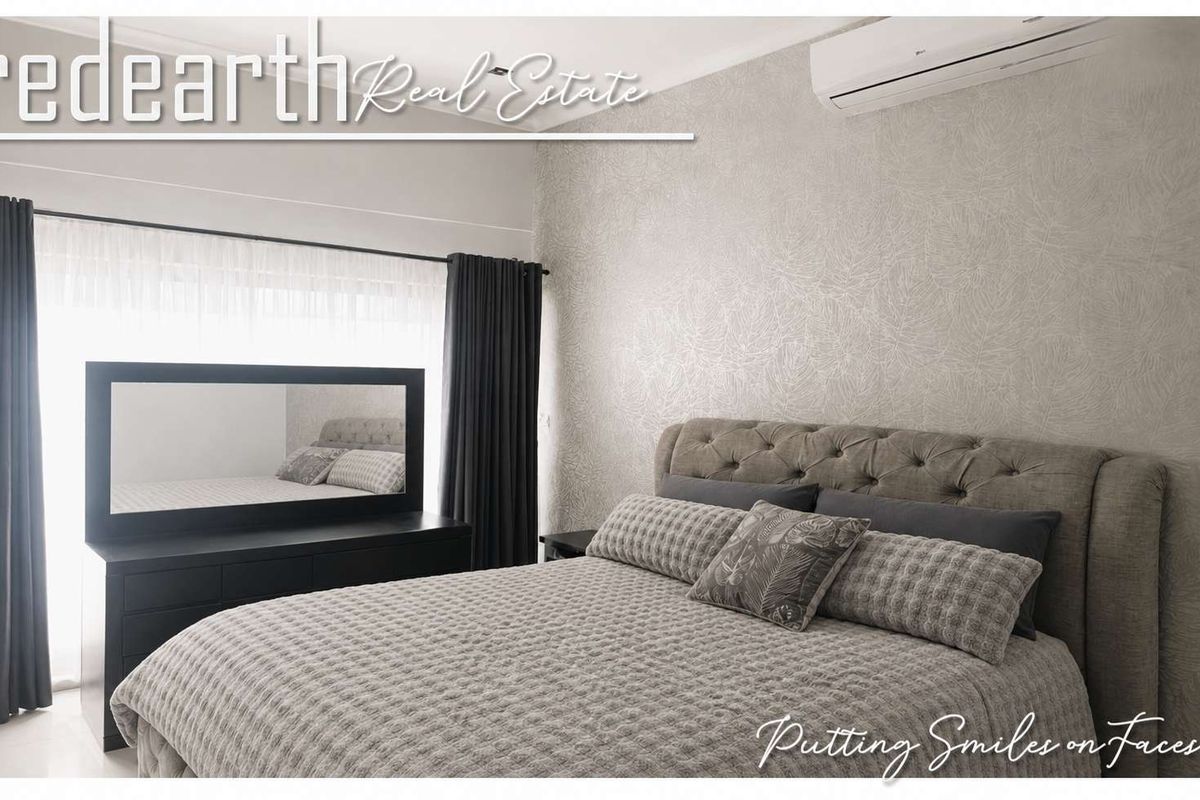 A well-maintained bedroom featuring textured wallpaper and a wall-mounted air conditioning unit.