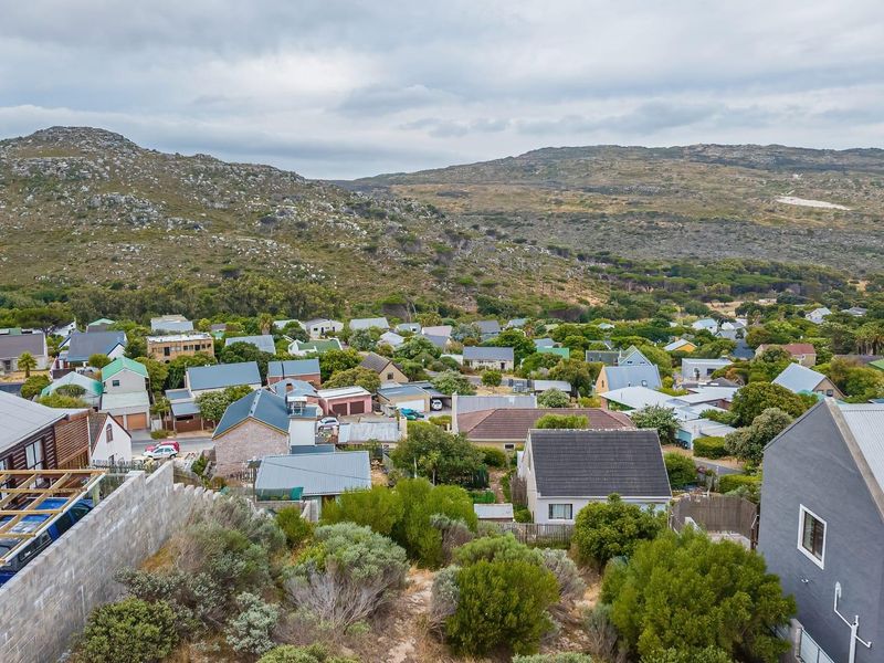 An elevated aerial view of a residential neighborhood nestled against a scenic mountain backdrop.