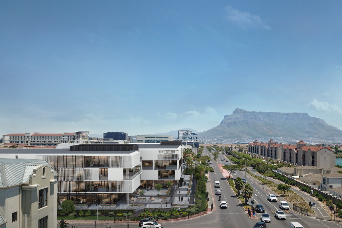 Aerial view of a modern office building complex featuring contemporary architecture, landscaped surroundings, and convenient access to major road networks.