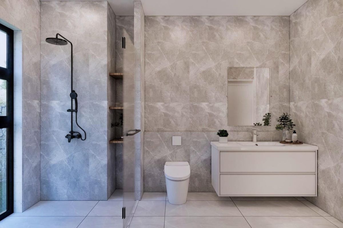 Modern bathroom featuring floor-to-ceiling marble-look tiling, a wall-mounted vanity, a sleek walk-in shower with black fixtures, and a wall-hung toilet.