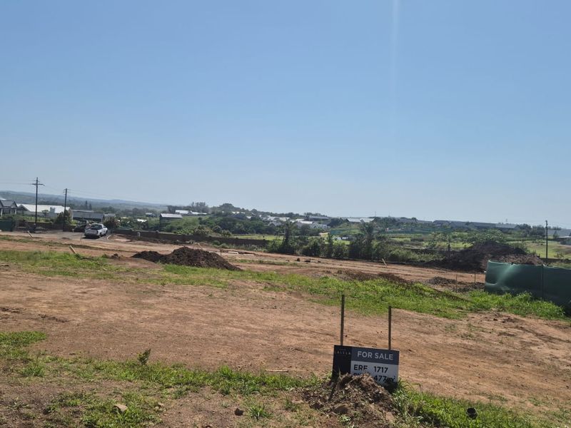 A vacant residential plot of land featuring open space and boundary fencing, suitable for new construction in a developing neighborhood.