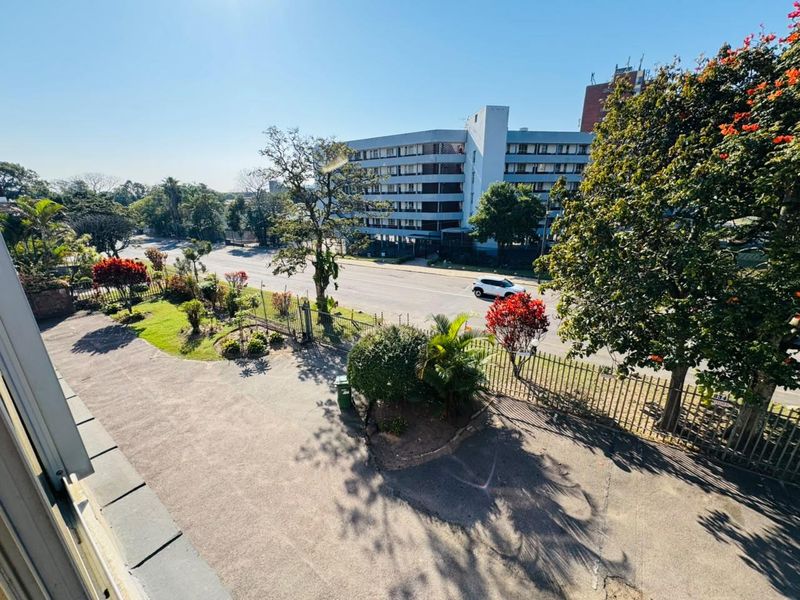 Elevated view overlooking the property driveway, perimeter fencing, and surrounding neighbourhood streetscape.