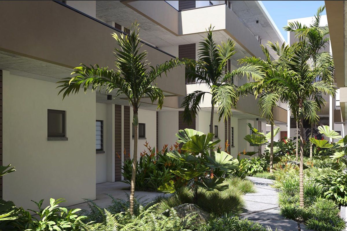 A modern apartment complex exterior featuring landscaped gardens, paved pathways, and contemporary architectural design with balconies.
