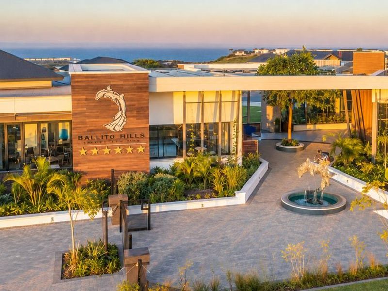 Aerial view of the Ballito Hills clubhouse entrance, featuring modern architectural design, landscaped courtyards, and a central water feature.