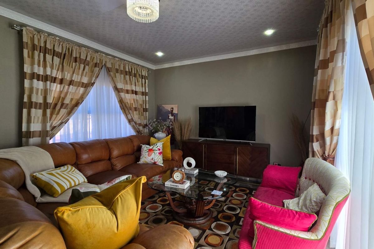 A comfortable living room featuring crown molding, recessed lighting, and a textured ceiling finish.