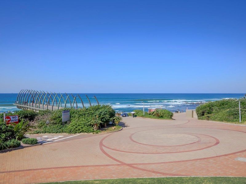 A scenic view of the coastal promenade and pier, showcasing the surrounding landscape and oceanfront setting.