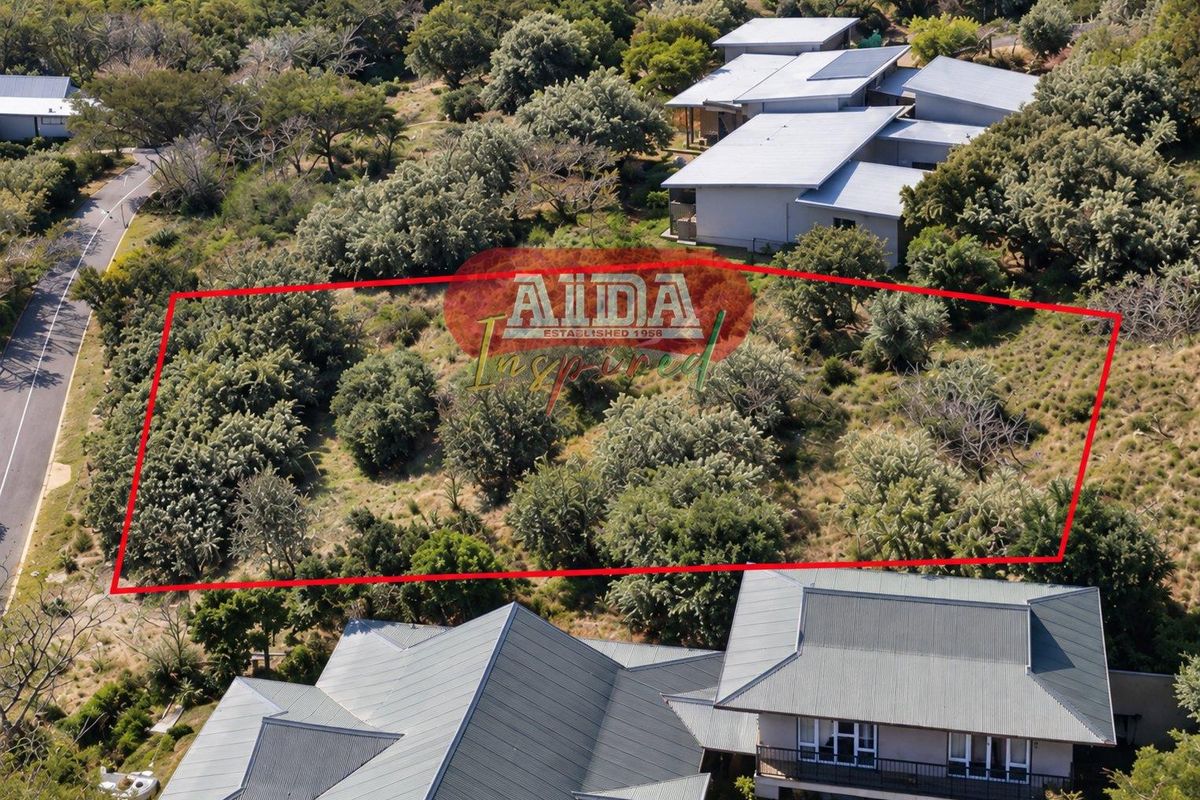 Aerial view of a vacant residential plot surrounded by established trees and neighboring properties.