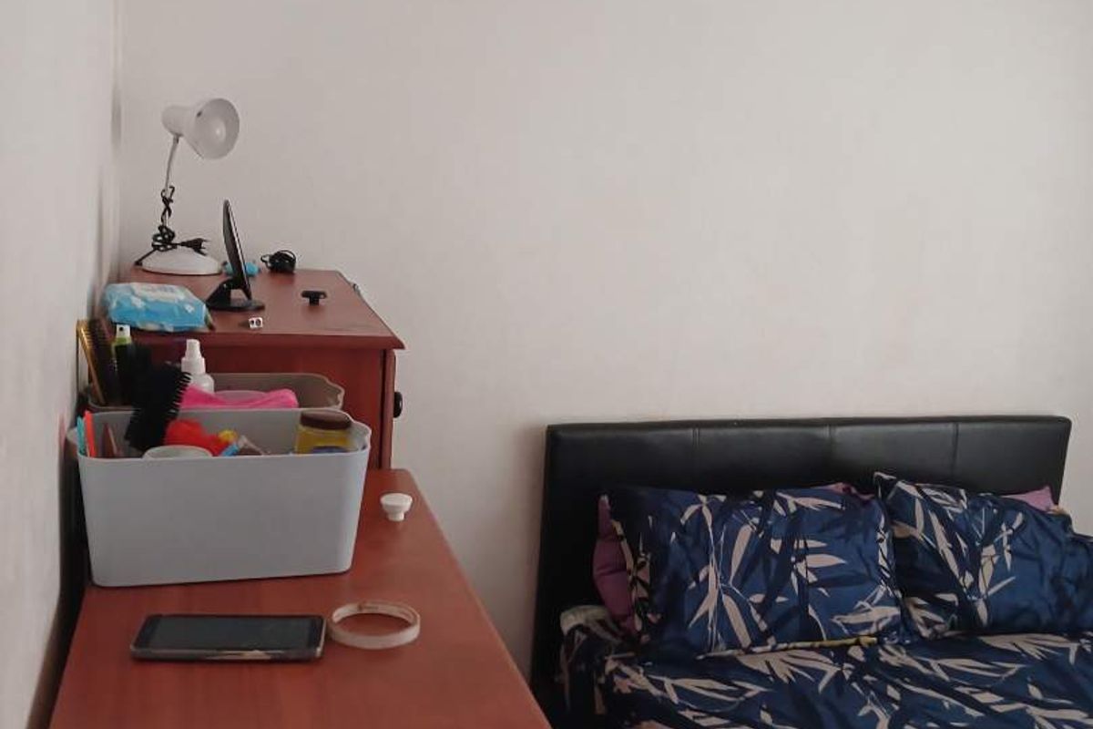 A standard bedroom featuring neutral walls and a simple layout, suitable for a comfortable sleeping space.