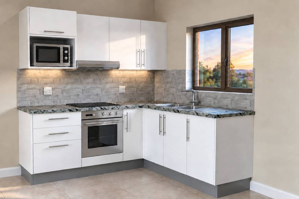 A modern, clean-lined kitchen featuring white cabinetry, integrated appliances, a tiled backsplash, and a granite-look countertop with a view through the window.