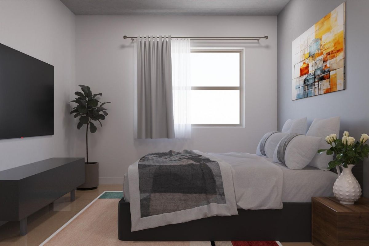 A well-lit bedroom featuring neutral wall tones, a window with curtain rod, and clean flooring.