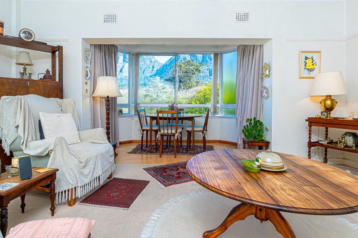 A comfortable living room featuring a large bay window with scenic mountain views, providing ample natural light and a pleasant outlook.